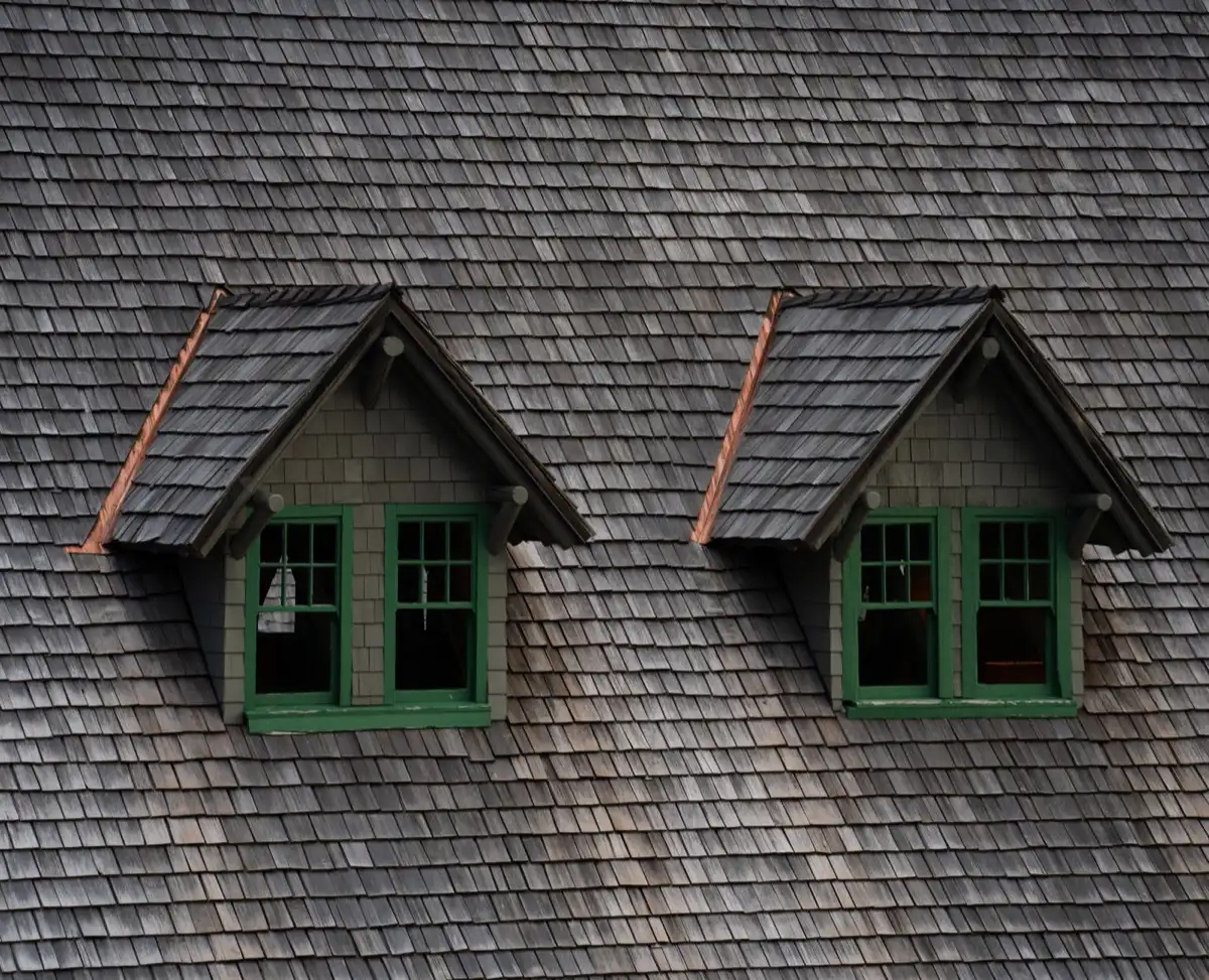 Dormers on a shingle roof in Ventura, CA, where step flashing and kickout flashing carry water past the walls
